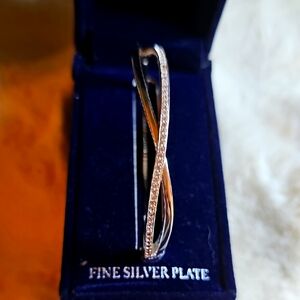 SPARKLE ALLURE Elegant Silver Plated Crossover Bangle.